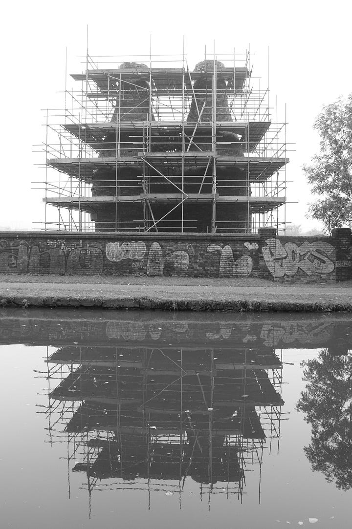 Picture one is black and white and shows two scaffolding-covered bottle shaped kilns reflected in the canal beneath. The second photo shows a more general view across the site with a big yellow digger sitting on top of the rubble.