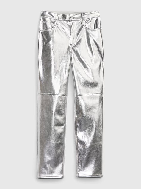 A pair of silver metallic jeans, a bright pink wool coat, and a pair of gold leopard earrings.