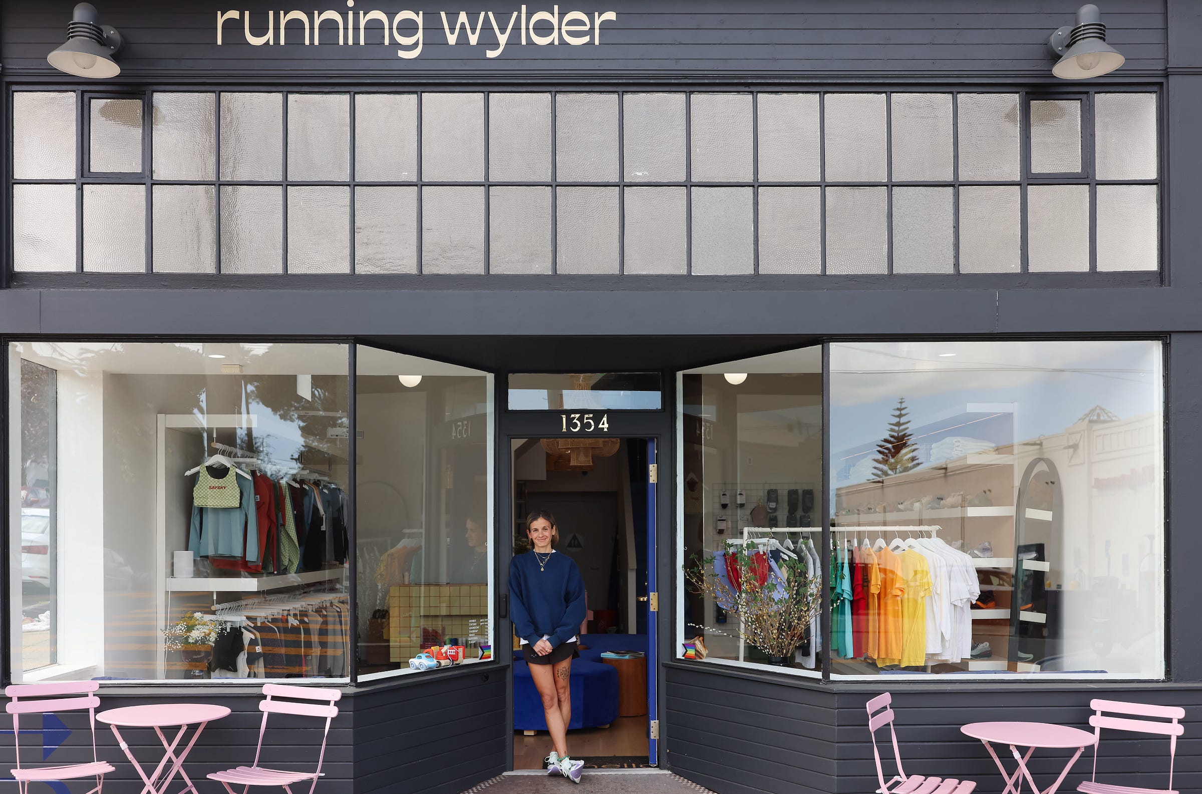 Exterior of the Running Wylder store at 1354 Castro Street with window displays of colorful apparel and pink bistro seating out front