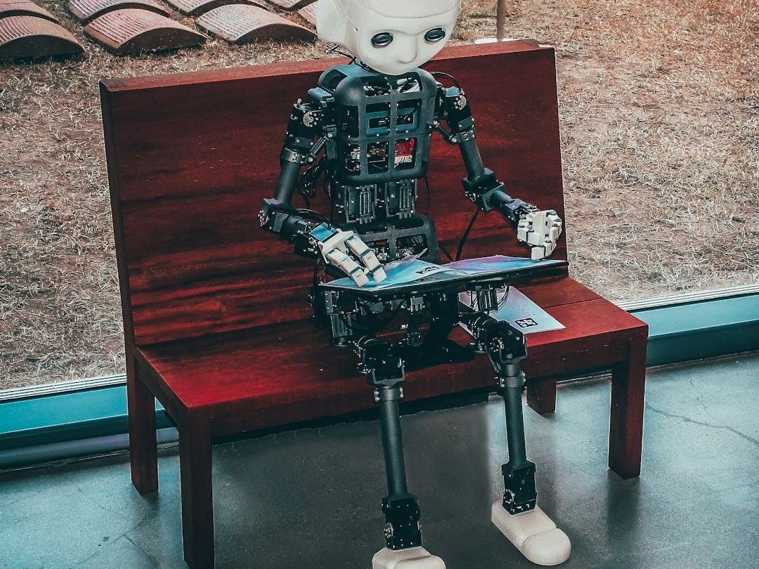 black and white robot toy on red wooden table black and white robot toy on red wooden table