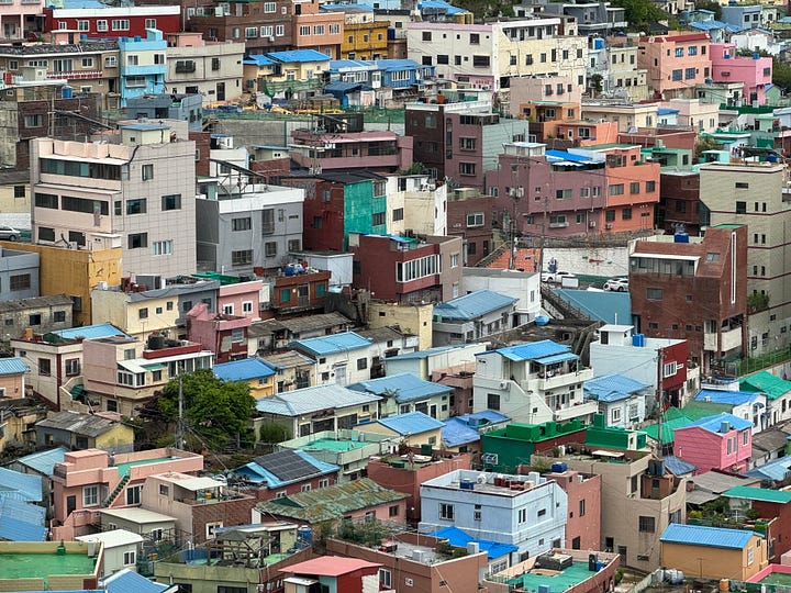 Left, colorful houses dotting a hillside. Right, Korean temple seated on the cliffside on the coastline.