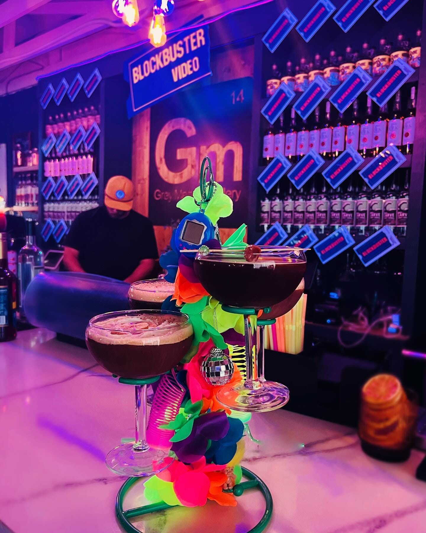 A bartender at a retro themed Blockbuster bar with fun cocktails