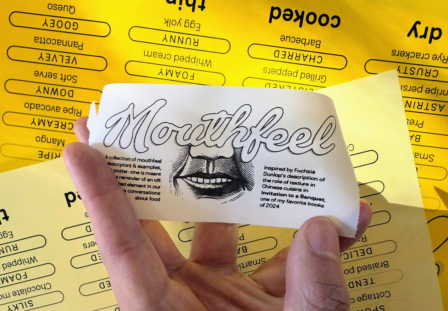Hand holding mouthfeel zine title page