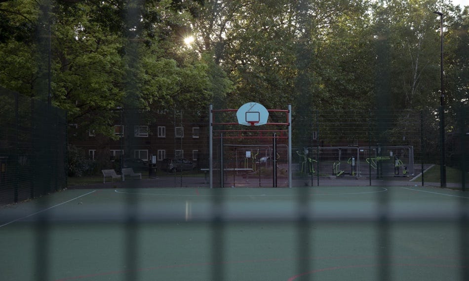 A basketball court with a hoop and a net

Description automatically generated