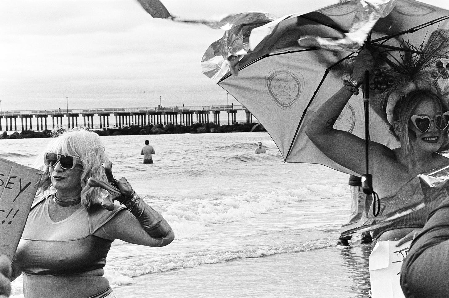 Two women posing for two different cameras