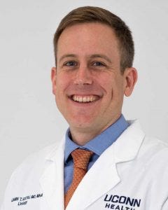 Dr. Ben Ristau portrait white coat