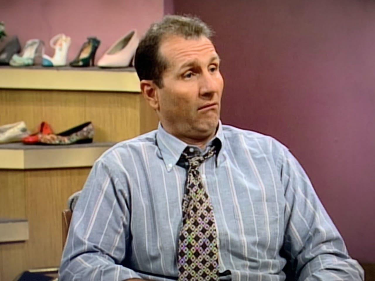 Here's the SEO alt text and captions for each image: Image 1 — Al Bundy Alt text: Al Bundy selling shoes at the mall in Married with Children, a portrait of displacement-era employment as managed decline