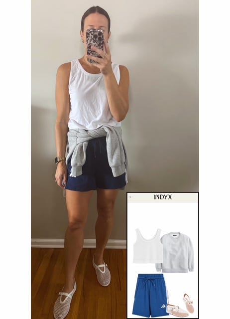 Woman wearing white scoop tank, navy Adidas shorts, white mesh flats, grey sweatshirt tied around waist, with slicked-back bun hairstyle. Woman wearing white scoop tank, navy Adidas shorts, white mesh flats, grey sweatshirt tied around waist, with slicked-back bun hairstyle.
