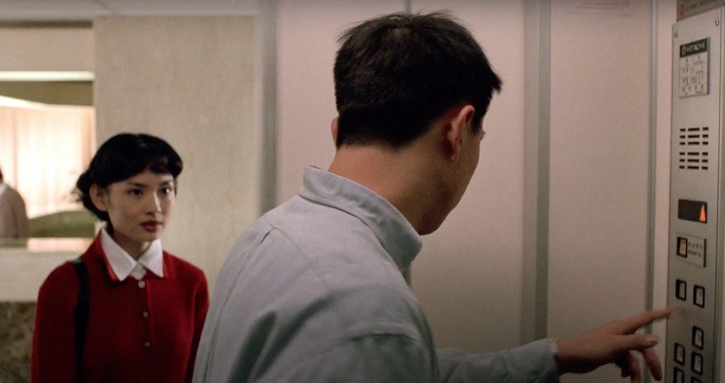 An elevator that Ming is inside of opens its door to reveal Qiqi standing right outside it in Edward Yang's movie A Confucian Confusion.