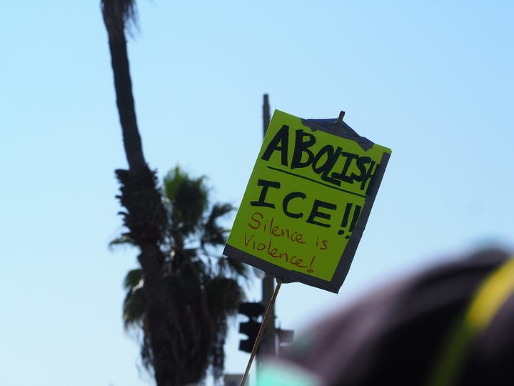 Protesters and California Highway Patrol officers facing each other on the 101 freeway in Los Angeles.