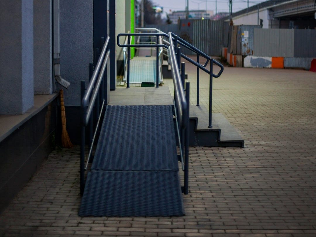 Accessible entrance ramp with stairs and handrails