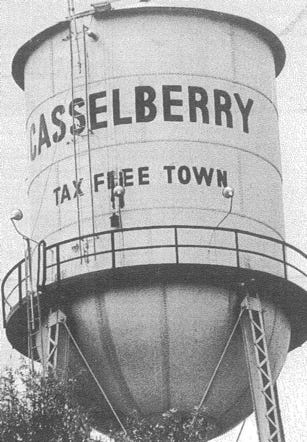 A large water tower with a sign on it

AI-generated content may be incorrect.
