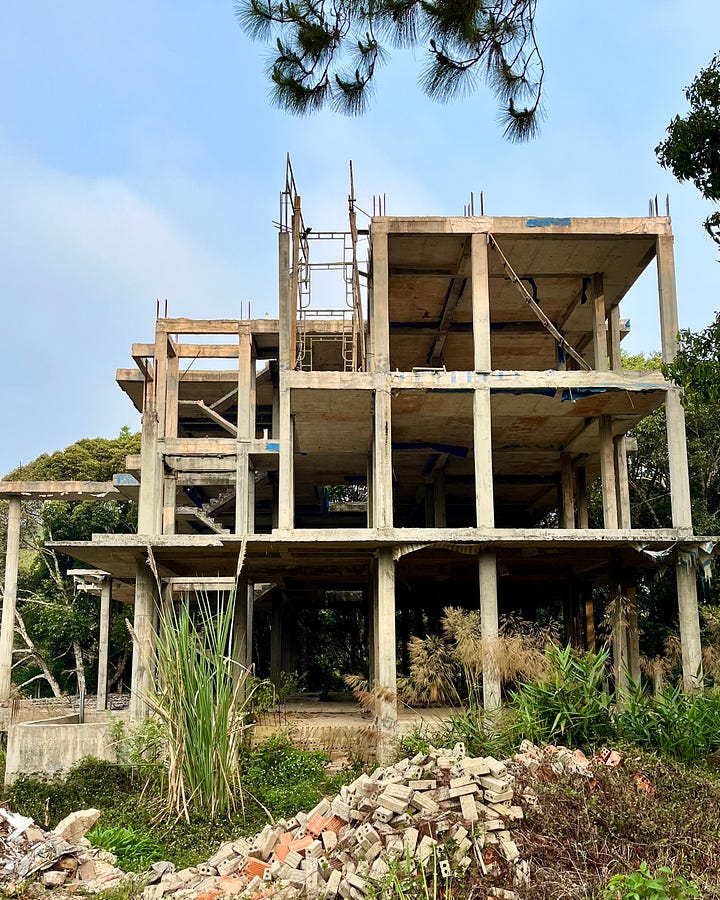 A house under construction and a scenic road