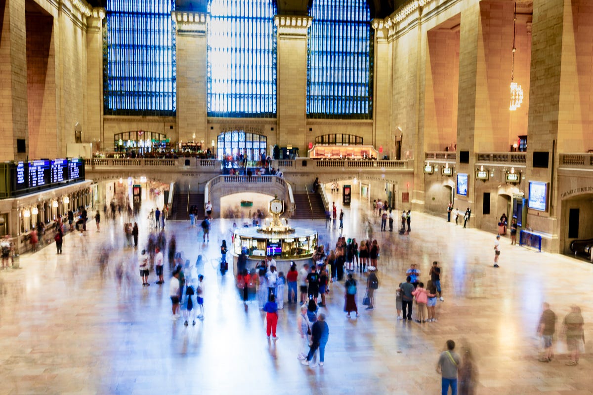 Long exposure at New York Grand Central Station with commuters blurred like ghosts Long exposure at New York Grand Central Station with commuters blurred like ghosts