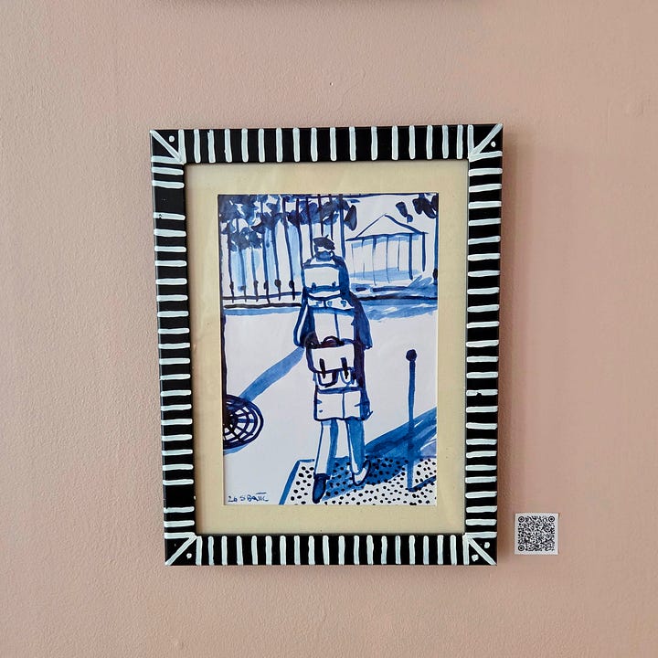 Framed art pieces in blue ink for sale. On a wall