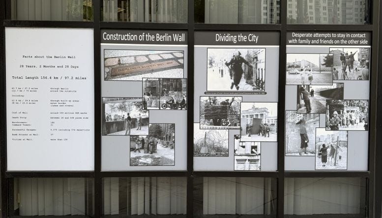 Figure 2: Display of construction of the wall on Miami-Dade Campus behind the Berlin Wall Segment. Courtesy of Casey M. Piket. Figure 2: Display of construction of the wall on Miami-Dade Campus behind the Berlin Wall Segment. Courtesy of Casey M. Piket.