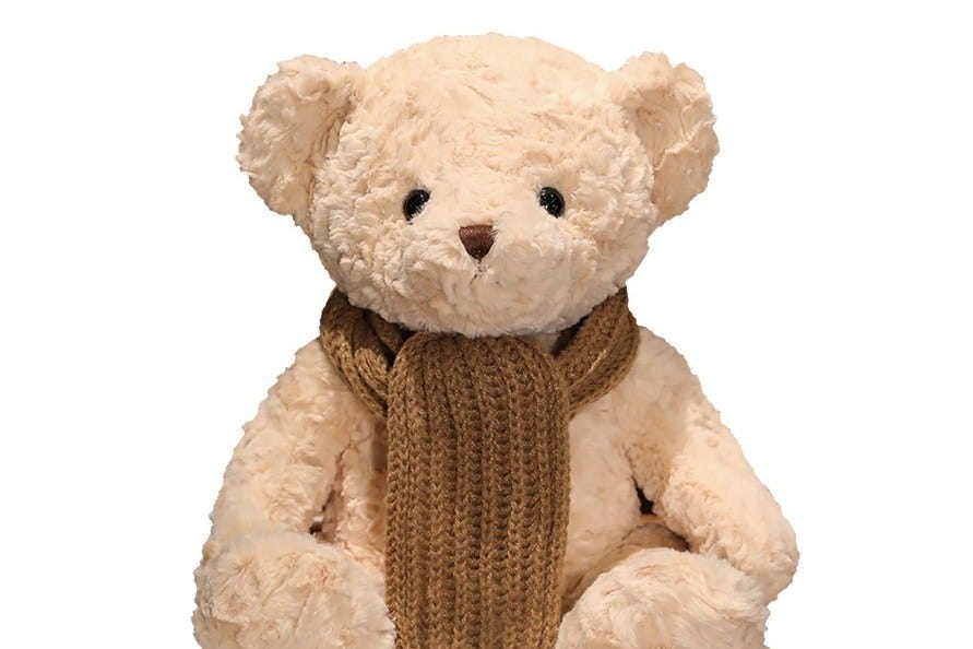 FoloToy Kumma AI teddy bear with a brown scarf.