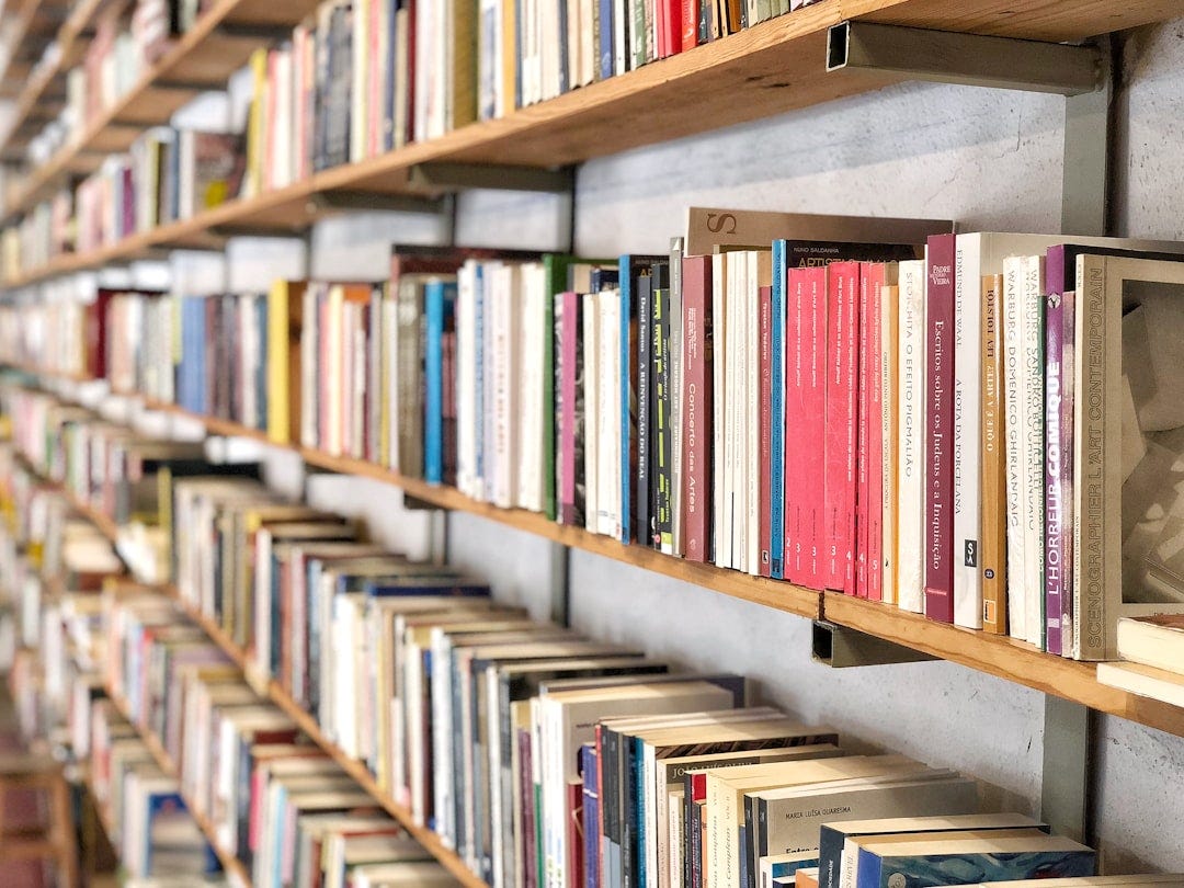books on brown wooden shelf books on brown wooden shelf