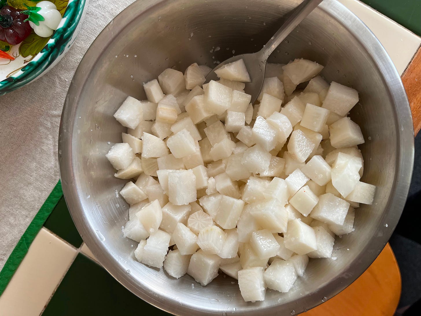 some cubed daikon salting in a stainless steel bowl some cubed daikon salting in a stainless steel bowl