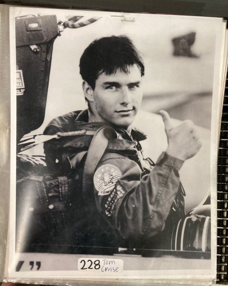 This may contain: an old photo of a young man in his pilot's uniform is being held up