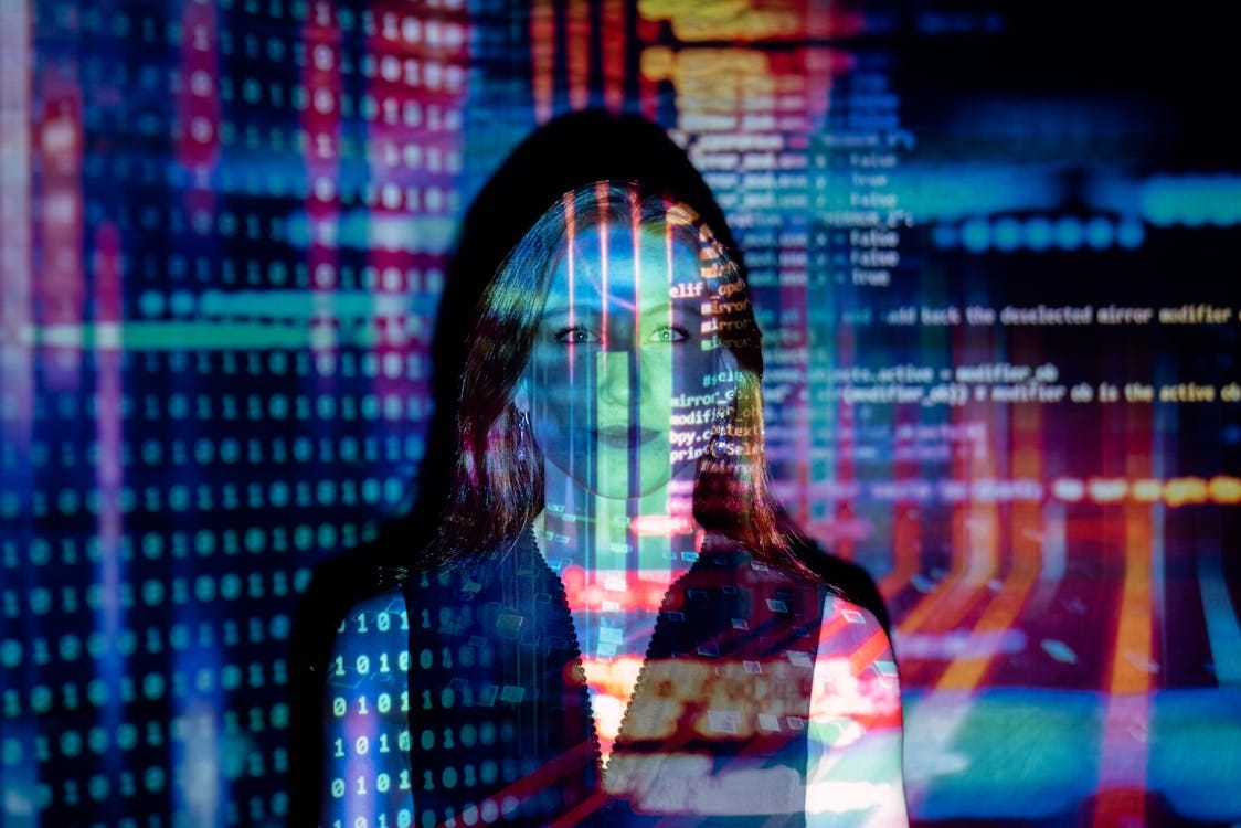 Free A woman with digital code projections on her face, representing technology and future concepts. Stock Photo