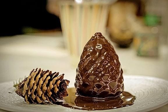 A pine cone recalls Marc Veyrat's signature, a cuisine close to its environment.