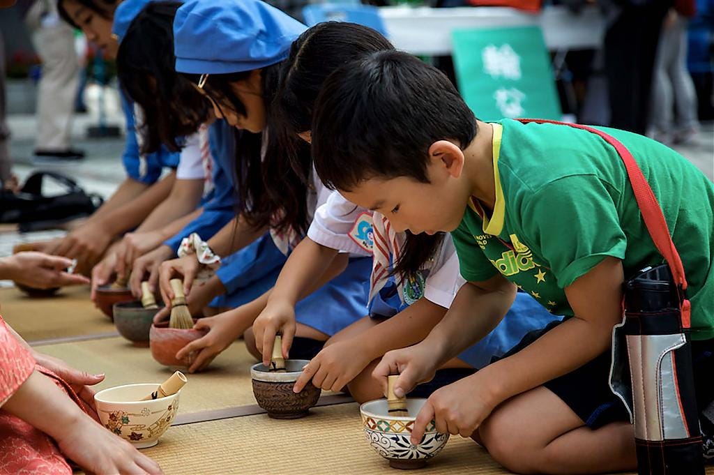 Japanese elementary school students practicing the tea ceremony Japanese elementary school students practicing the tea ceremony