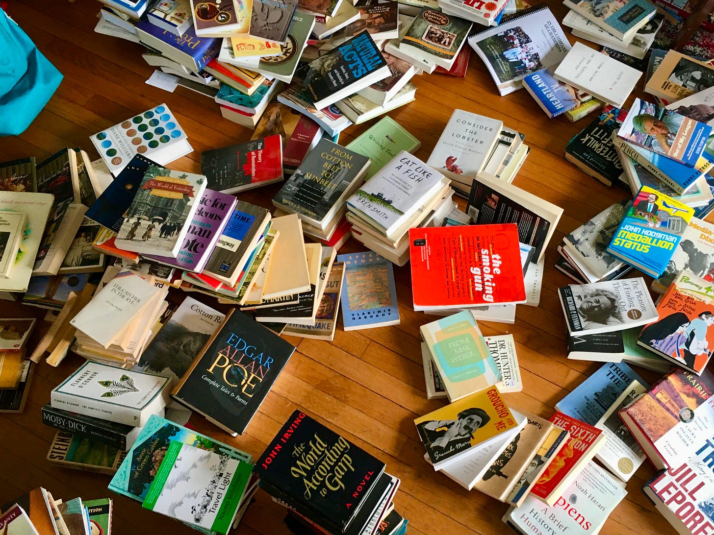 Stacks of books on a hardwood floor