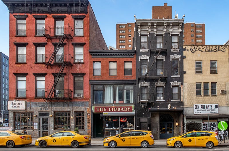 2023 photo by Steve Butcher of a row of parked yellow NY cabs on Ave A