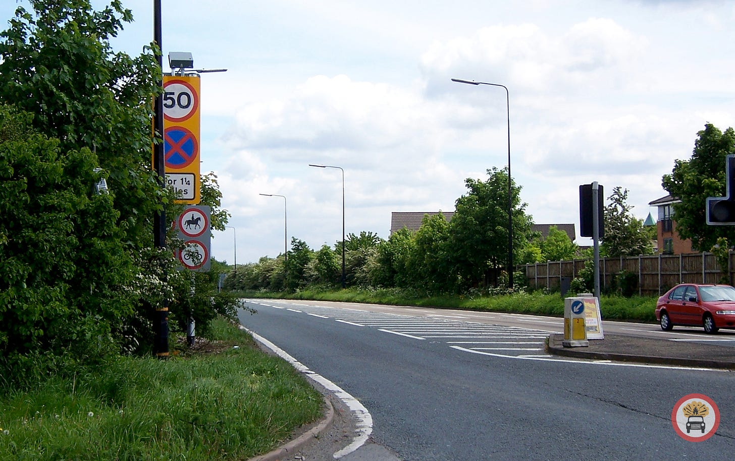 Photograph showing the same location as the previous picture, now in daylight. The motorway sign and work crew are gone and the road is open. On the left are a series of new road signs indicating a 50mph limit, clearway restrictions, and banning animals, cyclists, pedestrians and horse-drawn vehicles Photograph showing the same location as the previous picture, now in daylight. The motorway sign and work crew are gone and the road is open. On the left are a series of new road signs indicating a 50mph limit, clearway restrictions, and banning animals, cyclists, pedestrians and horse-drawn vehicles