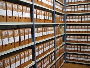 Brown archival boxes lined up on shelves