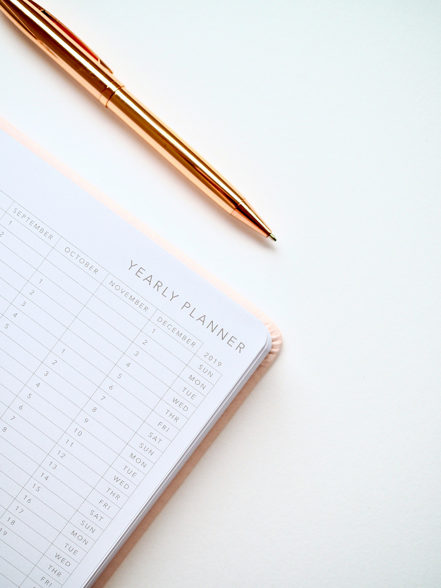 picture of a planner and a pen