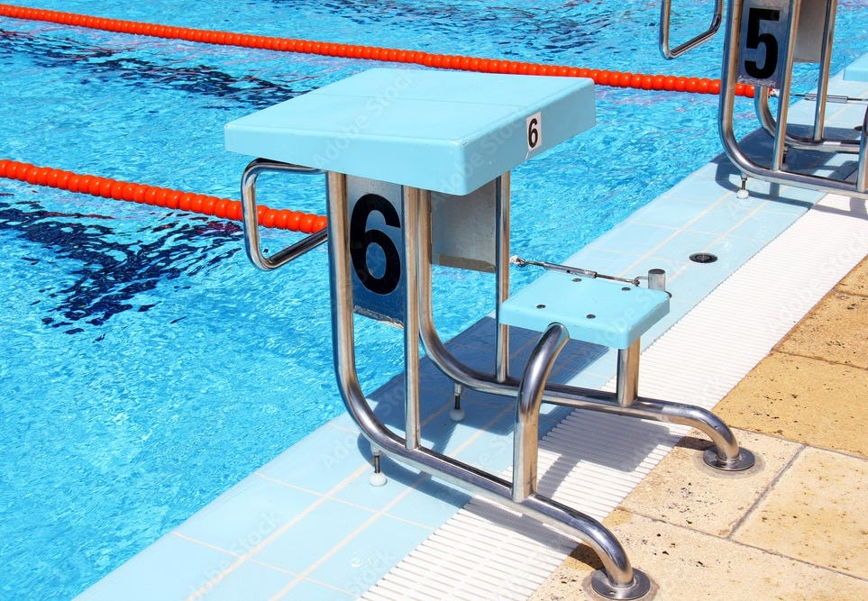 View of a row of diving boards in a Olympic pool. Stock Photo | Adobe Stock