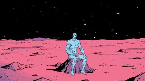 Doctor Manhattan sits on a rock on mars, holding an old photograph, in Watchmen, DC Comics (1986).