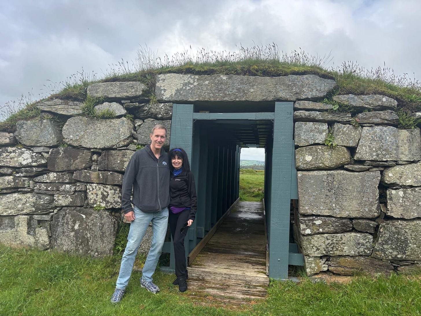 Man and woman standing at the limestone entrance of a ringfort in County Cork Ireland