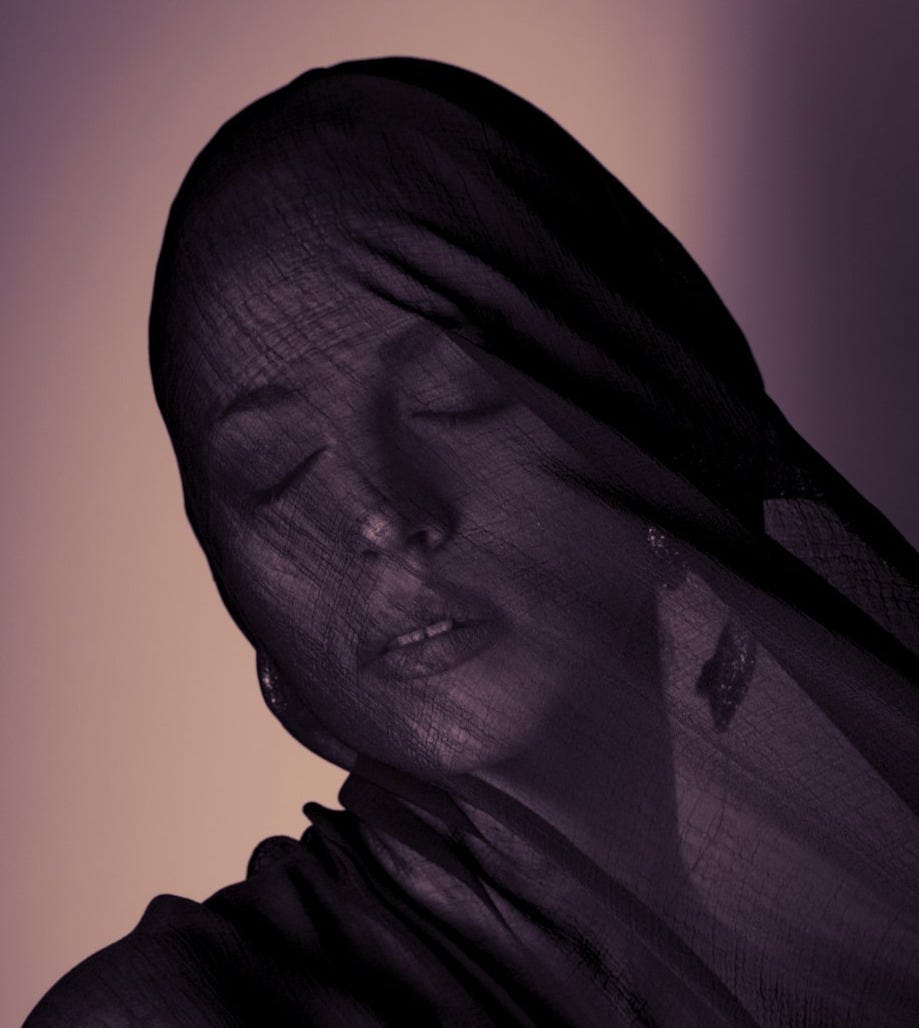 Woman with eyes closed covered by dark fabric Woman with eyes closed covered by dark fabric