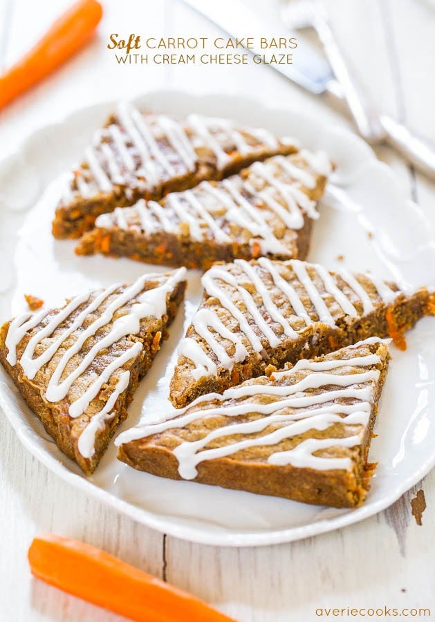 Soft carrot cake bars with cream cheese glaze on a plate. 