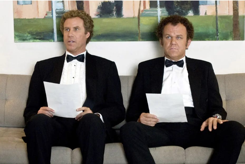 Two men in tuxedos sitting side by side reading papers with serious expressions, suggesting scrutiny, evaluation, or comparison. Two men in tuxedos sitting side by side reading papers with serious expressions, suggesting scrutiny, evaluation, or comparison.