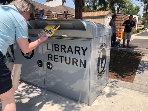 Ribbon Cutting, Chris Slama, and a mom and chld inside the library