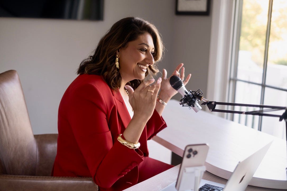 Deepali speaking into a microphone