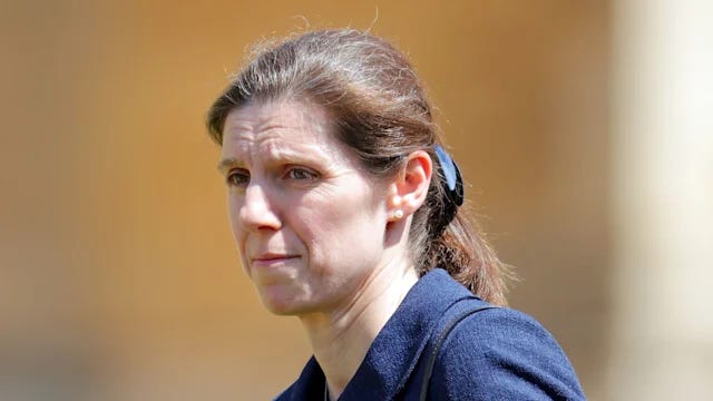 Maria Teresa looking sad wearing a navy coat