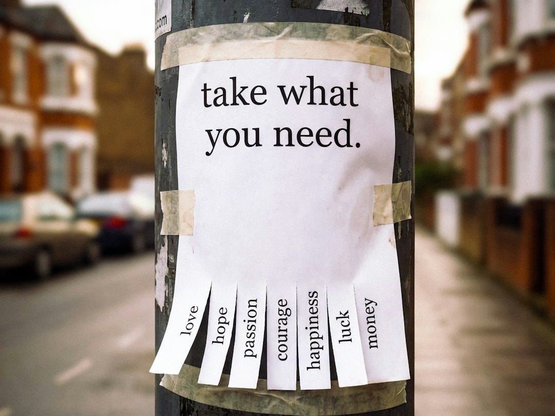 A sign on a pole reads 'take what you need.'