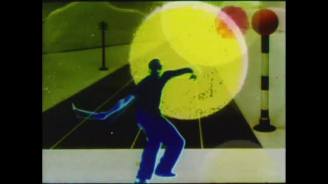 Man taking tennis stroke, with a Belisha beacon in the background Man taking tennis stroke, with a Belisha beacon in the background