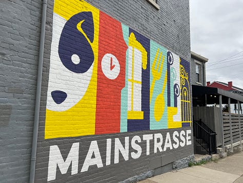 Mural on Rosie's Social Club, Glockenspeil at Goebel Park, Goose Girl Fountain, Street sign reflecting WWII anti-German changes, statuary detail at Mother of God church, Mural of Mainstrasse, Cathedral Basilica, Strasse Haus