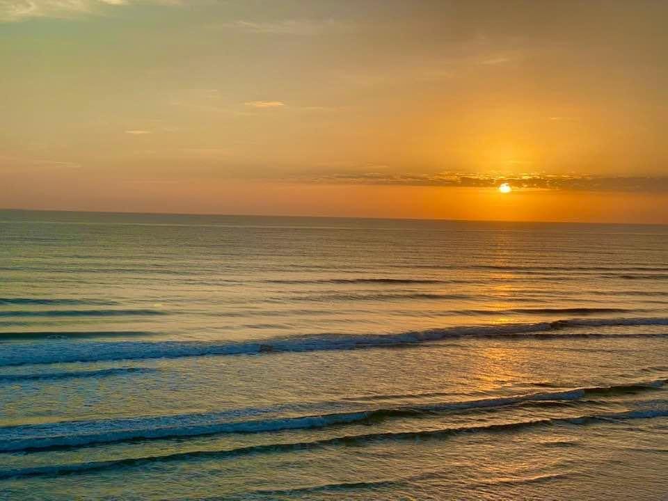 May be an image of nature, beach, coast, ocean, twilight and sky
