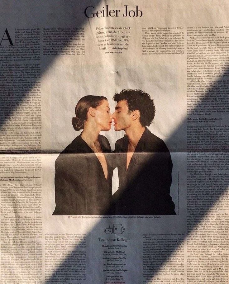 This may contain: a man and woman kissing in front of a newspaper page with the words geller job on it