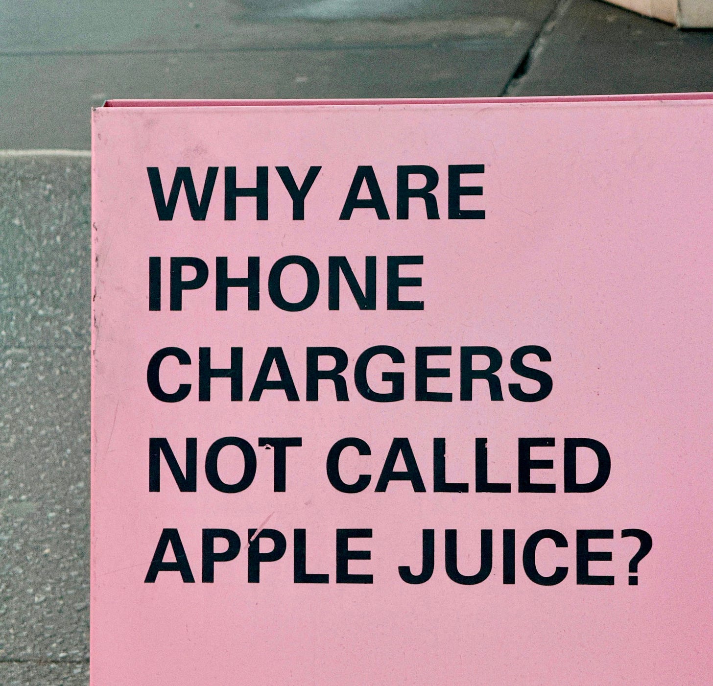 A pink sign on the side of the road