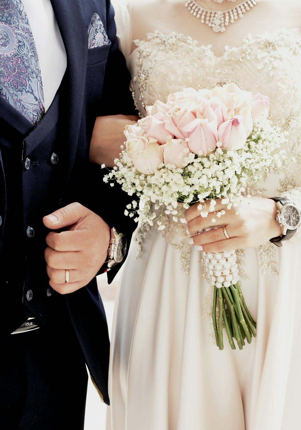 woman in white wedding dress holding bouquet of flowers