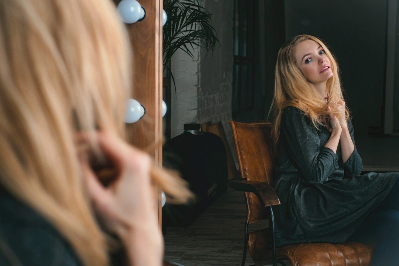 woman looking in mirror