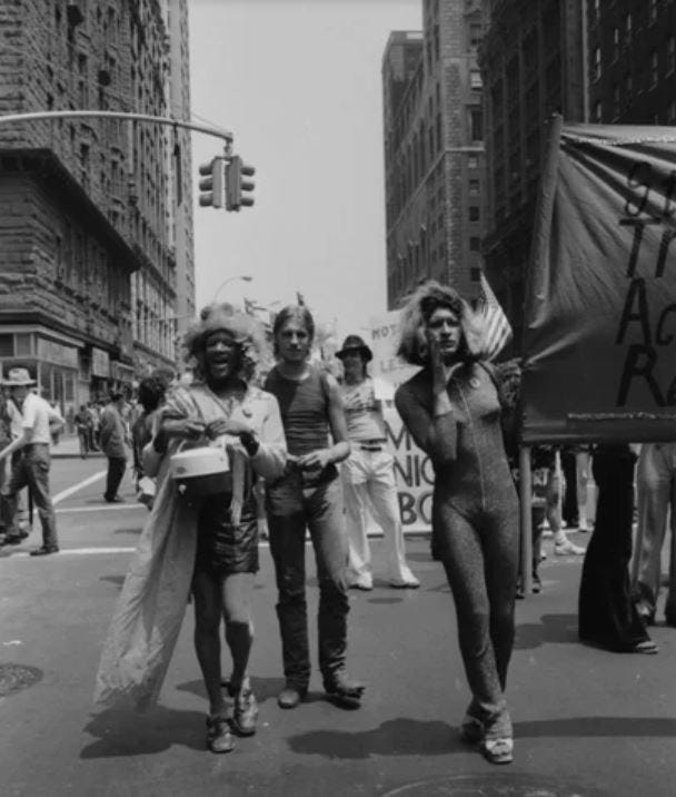 Sylvia and Marsha protesting through the streets of NYC A black and white photo of Marsha P. Johnson and Sylvia Rivera at a protest